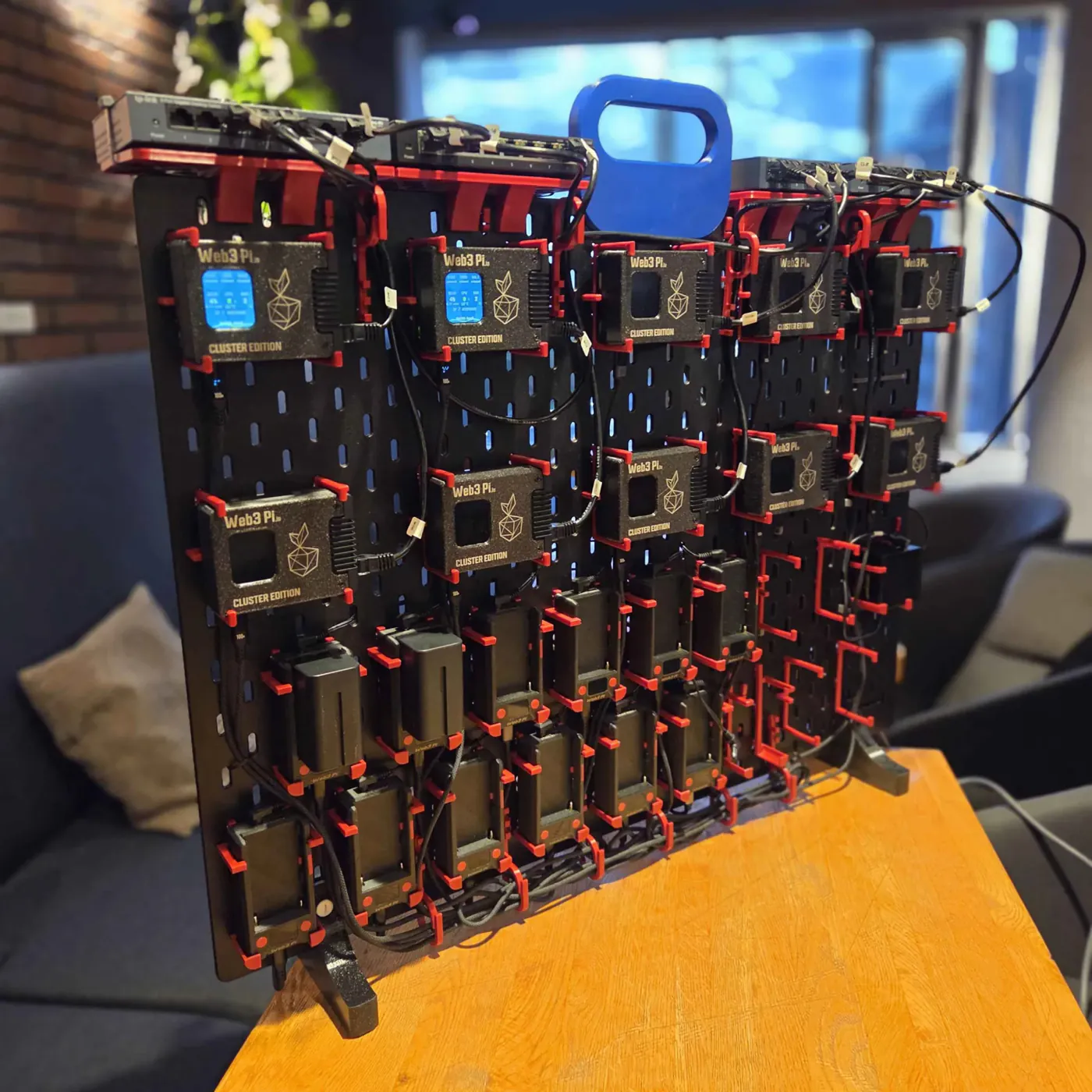 Angled view of the Web3 Pi Cluster Edition board with Raspberry Pi 5 nodes in Web3 Pi cases, UPS battery modules and gigabit switches